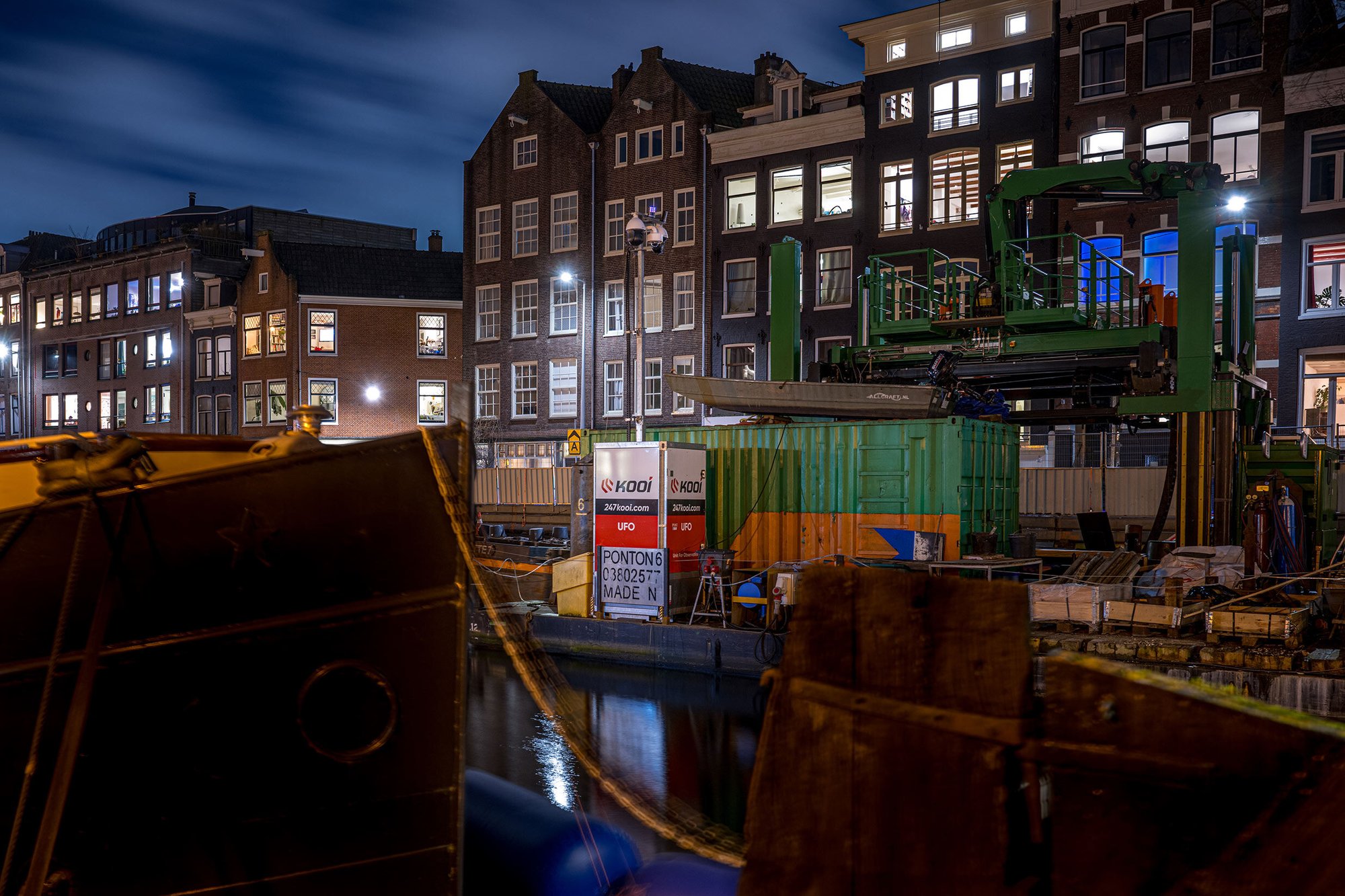 Kooi surveillance system monitoring a canal-side construction site at night in a historic urban area, ensuring security and safety during infrastructure development.