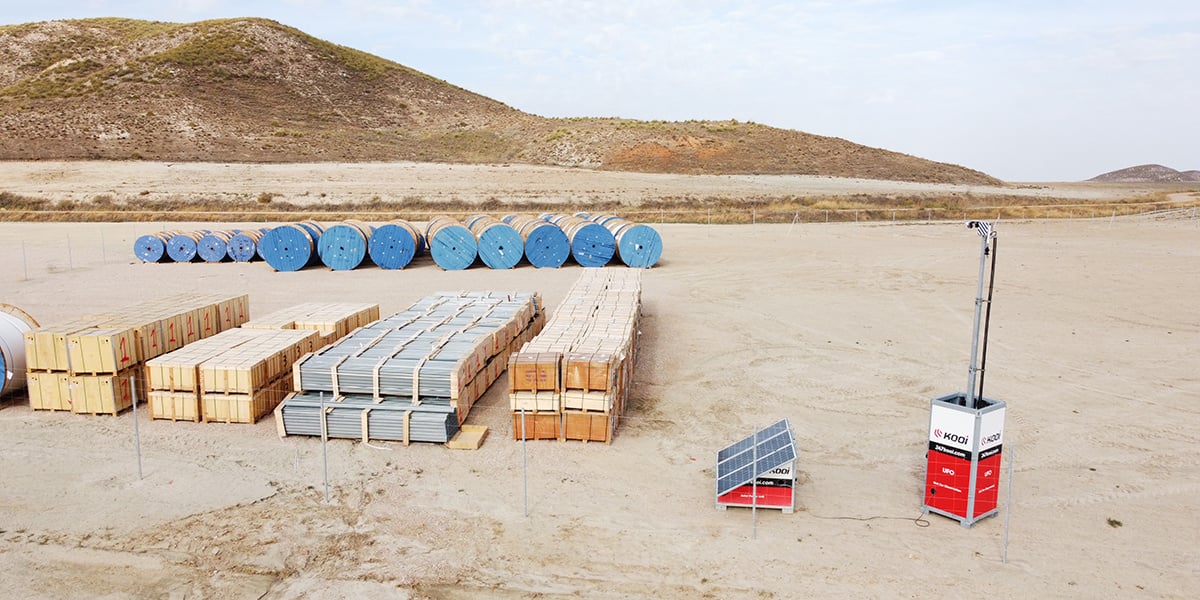 Kooi UFO security unit with a solar panel protecting stored construction materials on a remote site, showcasing a reliable, innovative, and sustainable approach to site security.