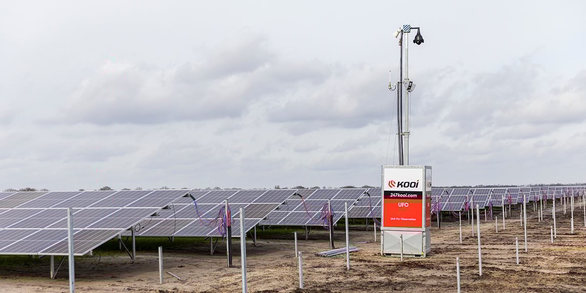 Kooi UFO security unit monitoring a solar farm, ensuring reliable, innovative, and sustainable protection for renewable energy sites.