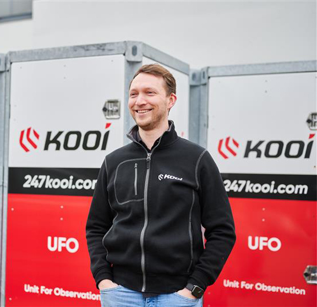 Jelle van Tol in front of two mobile surveillance units